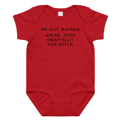 "I’m not insane   We’re just mentally creative" printed on a red baby jersey bodysuit laying on a flat surface amongst other clothes