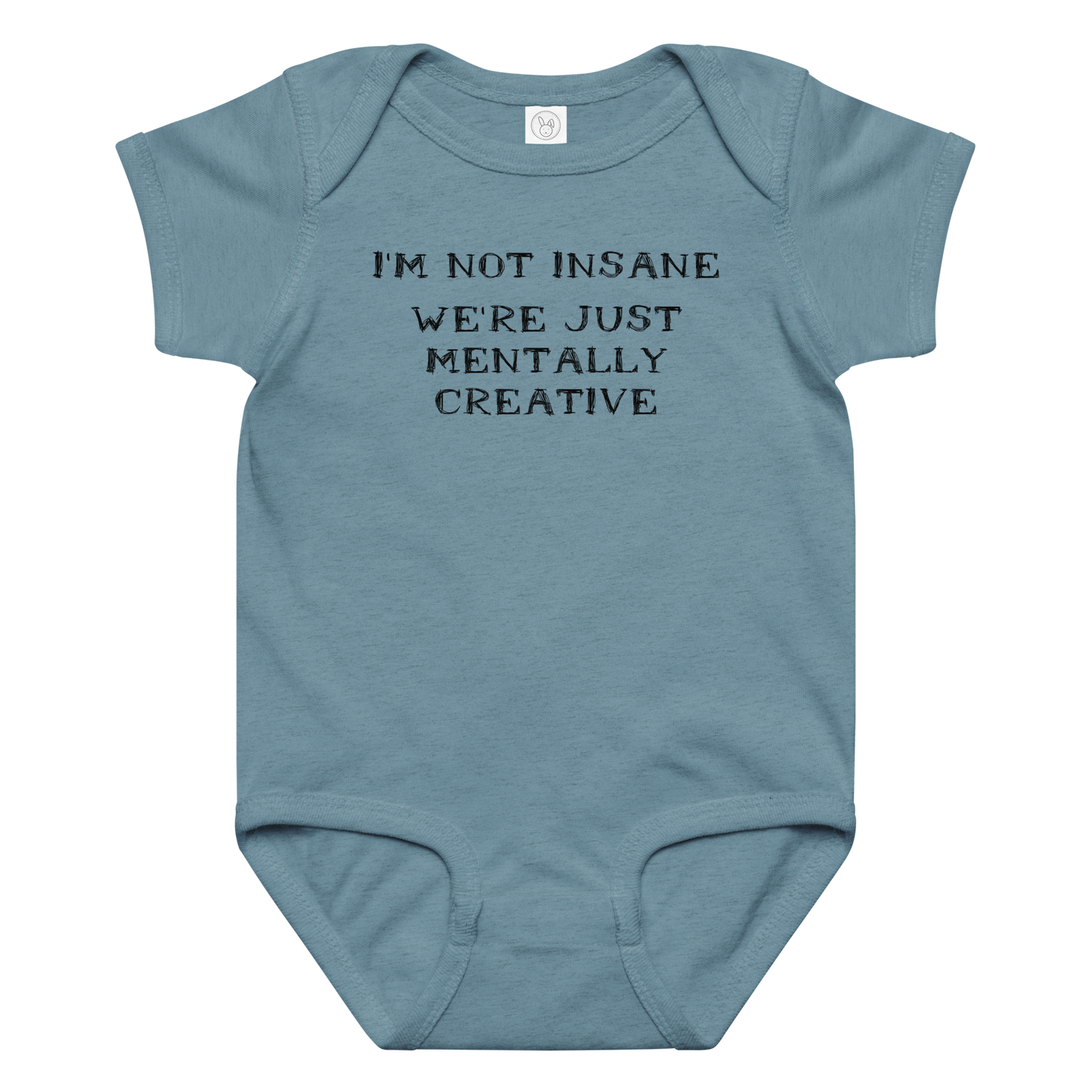 "I’m not insane   We’re just mentally creative" printed on a vintage indigo baby jersey bodysuit laying on a flat surface amongst other clothes
