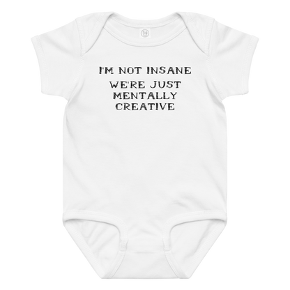 "I’m not insane   We’re just mentally creative" printed on a white baby jersey bodysuit laying on a flat surface amongst other clothes