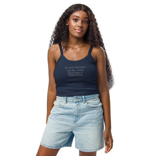 "I’m not insane   We’re just mentally creative" printed on a solid navy blend women's micro-rib tanktop worn by a female