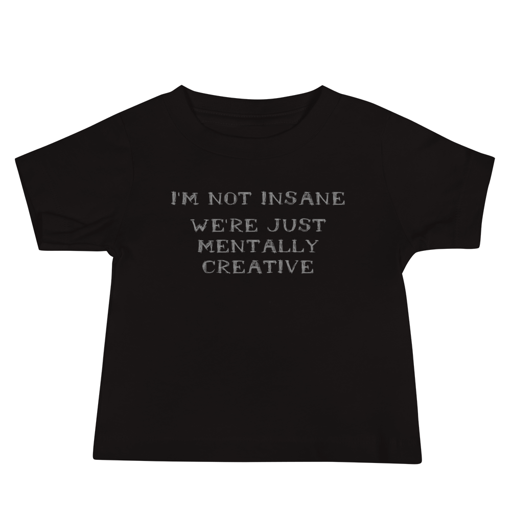 "I’m not insane   We’re just mentally creative" printed on a black baby jersey short sleeve tee laying on a flat surface