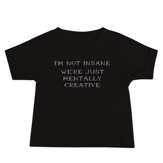 "I’m not insane   We’re just mentally creative" printed on a black baby jersey short sleeve tee laying on a flat surface