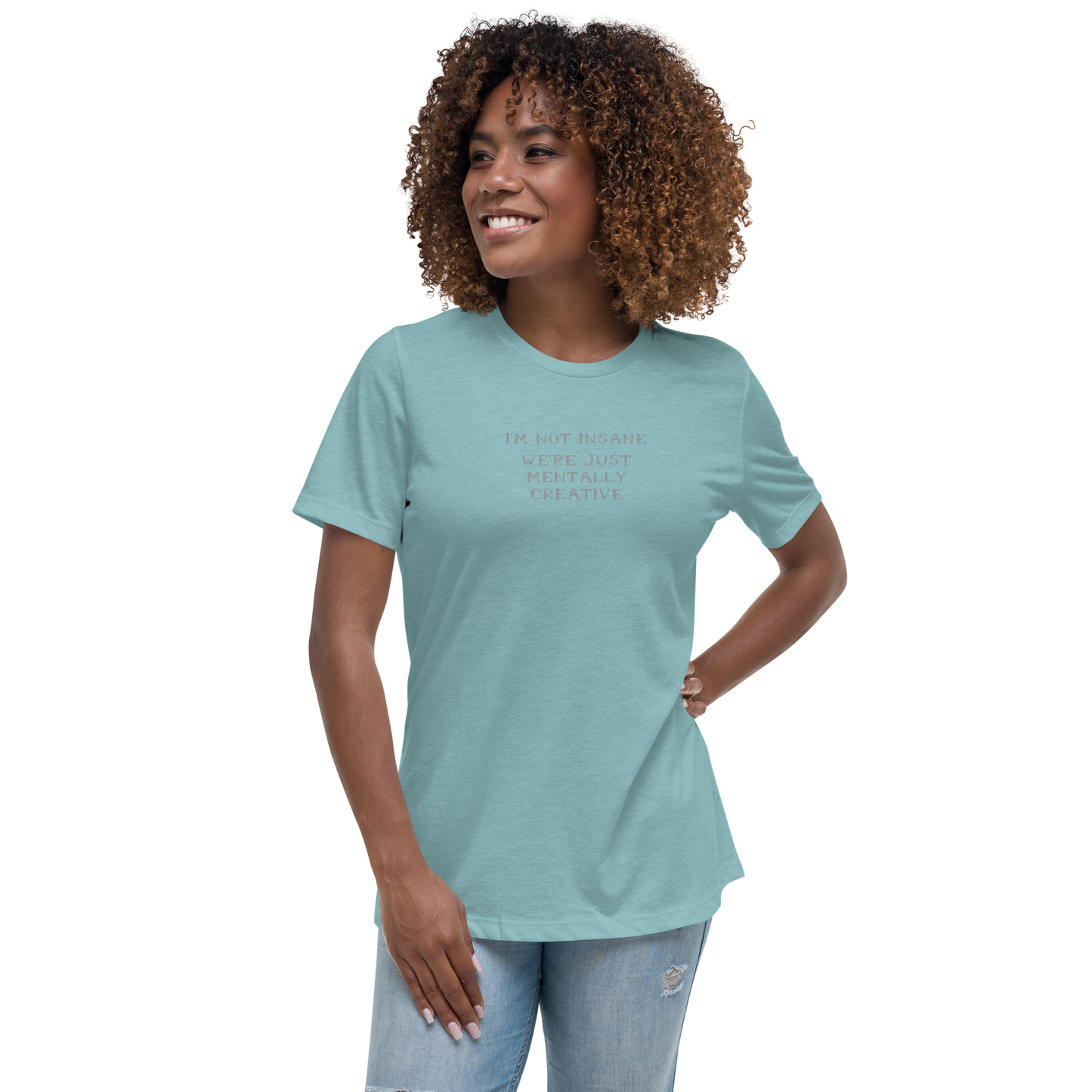 "I’m not insane   We’re just mentally creative" printed on a heather blue lagoon women's relaxed t-shirt worn by a female