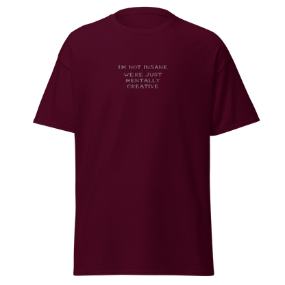 "I’m not insane   We’re just mentally creative" printed on a maroon on an invisible body