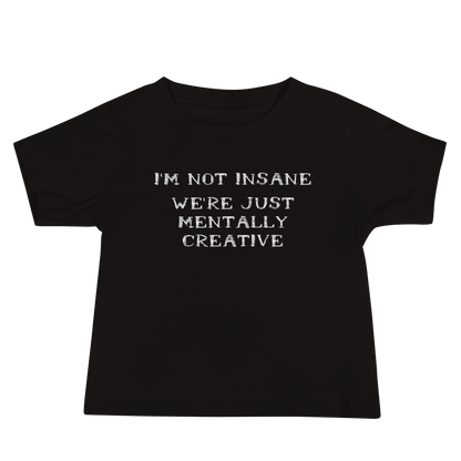 "I’m not insane   We’re just mentally creative" printed on a black baby jersey short sleeve tee laying on a flat surface