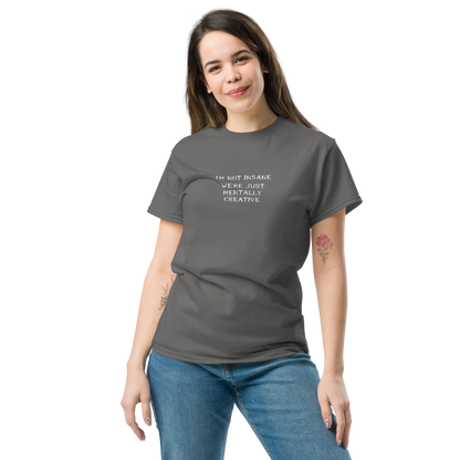 "I’m not insane   We’re just mentally creative" printed on a charcoal unisex classic tee worn by a female
