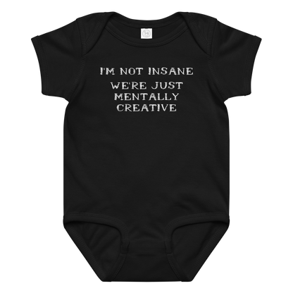 "I’m not insane   We’re just mentally creative" printed on a black baby jersey bodysuit laying on a flat surface amongst other clothes