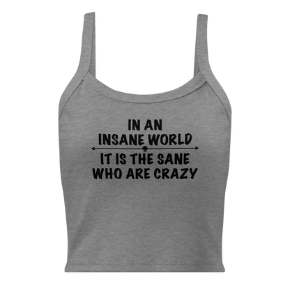 "In an insane world, it is the sane who are crazy" printed on a athletic heather women's micro-rib tanktop laying on a flat surface