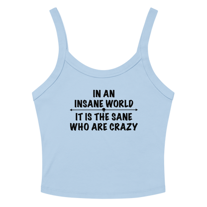 "In an insane world, it is the sane who are crazy" printed on a solid baby blue blend women's micro-rib tanktop laying on a flat surface amongst sunglasses and shorts