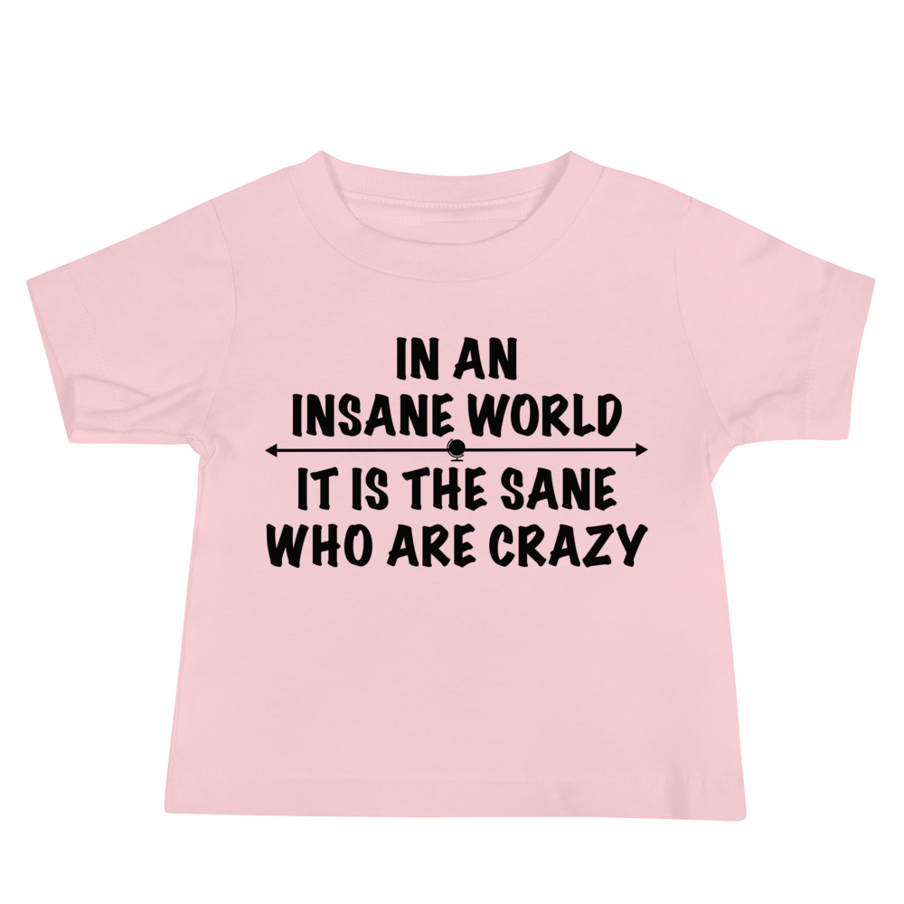 "In an insane world, it is the sane who are crazy" printed on a pink baby jersey short sleeve tee laying on a flat surface