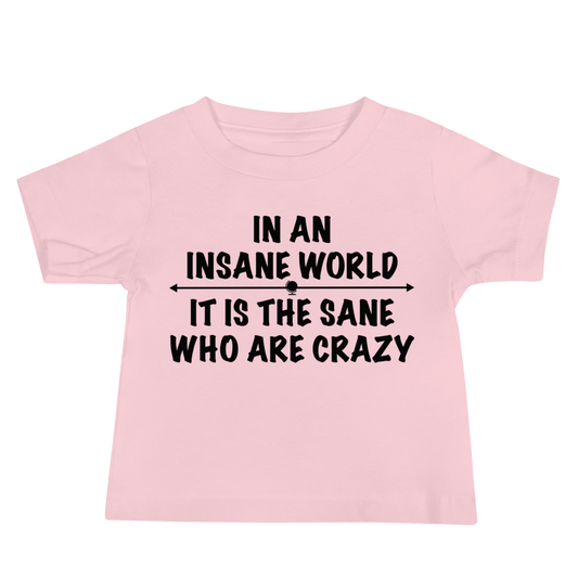 "In an insane world, it is the sane who are crazy" printed on a pink baby jersey short sleeve tee laying on a flat surface