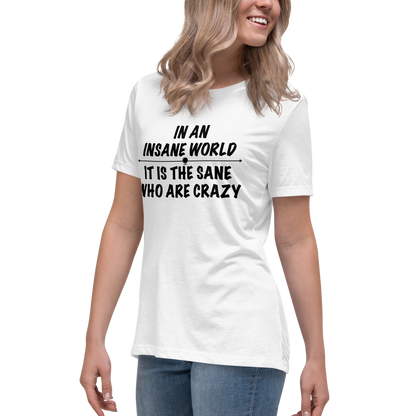 "In an insane world, it is the sane who are crazy" printed on a white women's relaxed t-shirt worn by a female