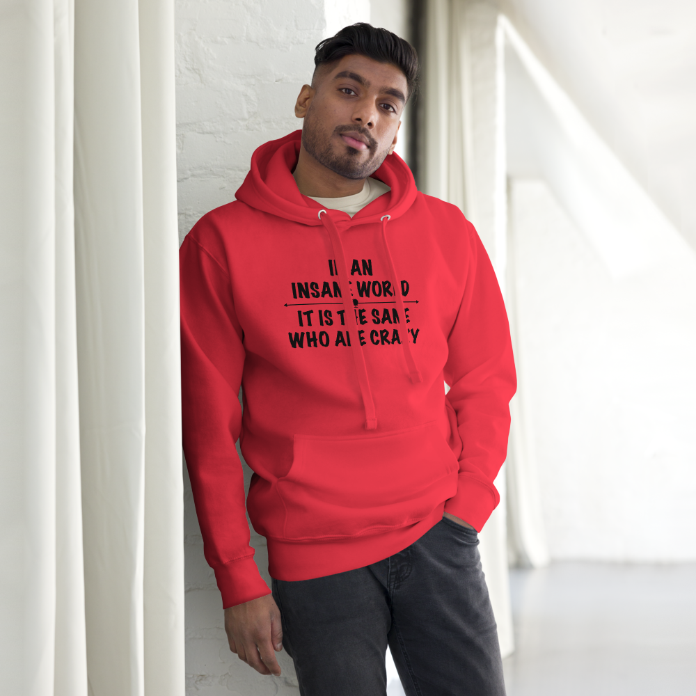 "In an insane world, it is the sane who are crazy" printed on a team red unisex hoodie worn by a male