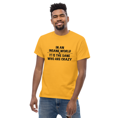 "In an insane world, it is the sane who are crazy" printed on a gold unisex classic tee worn by a male