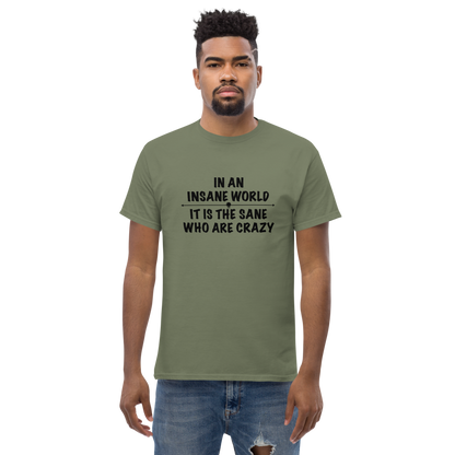 "In an insane world, it is the sane who are crazy" printed on a military green unisex classic tee worn by a male