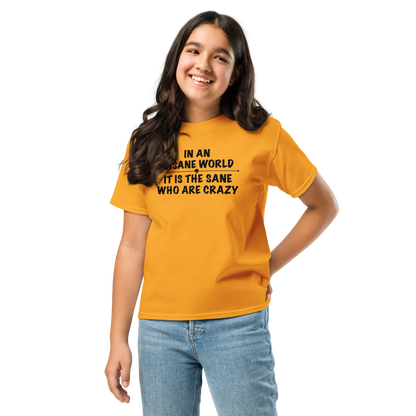 "In an insane world, it is the sane who are crazy" printed on a gold youth classic tee worn by a female