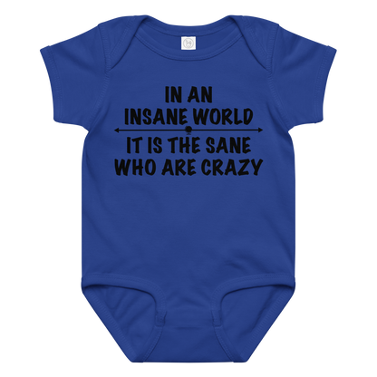 "In an insane world, it is the sane who are crazy" printed on a royal baby jersey bodysuit laying on a flat surface amongst other clothes