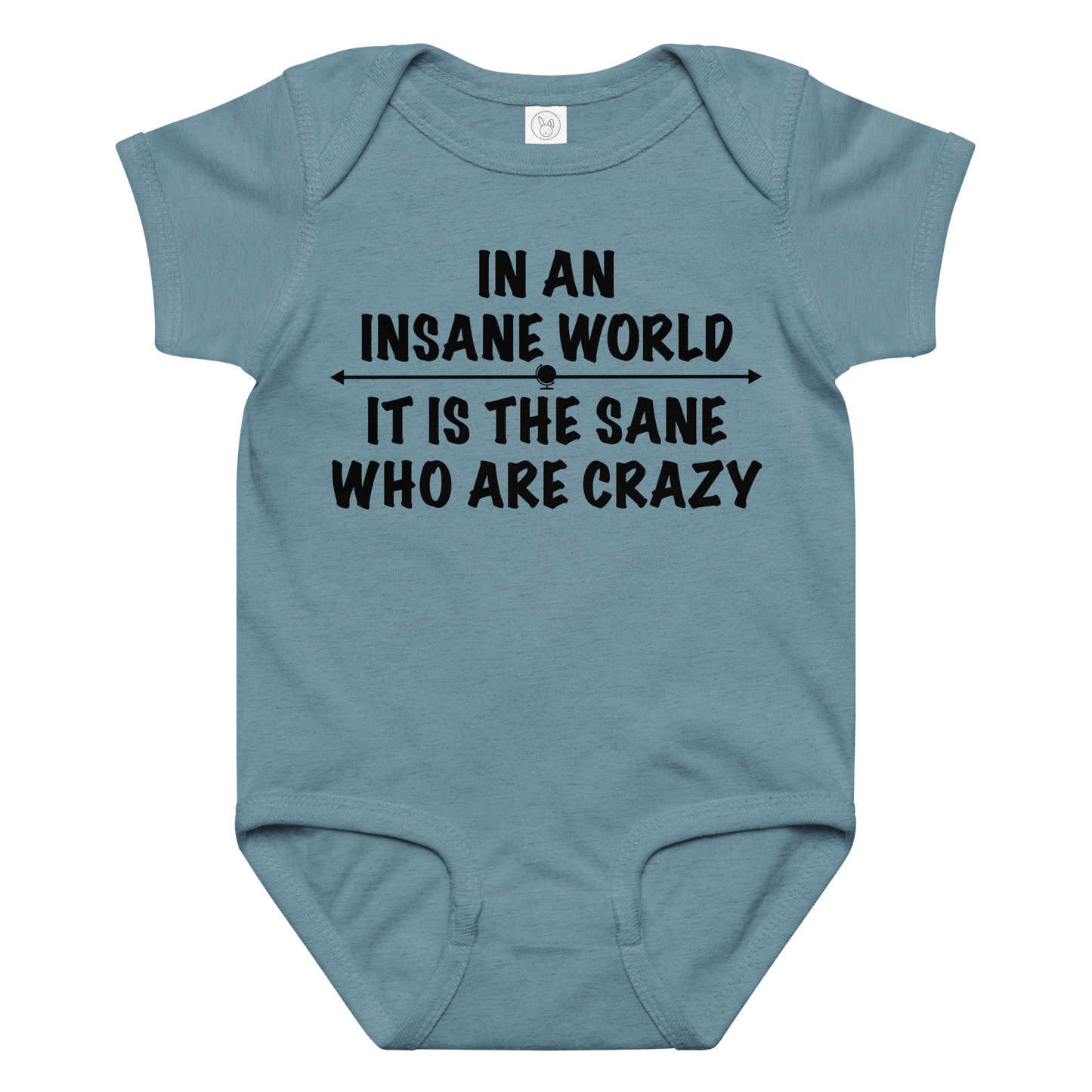"In an insane world, it is the sane who are crazy" printed on a vintage indigo baby jersey bodysuit laying on a flat surface amongst other clothes