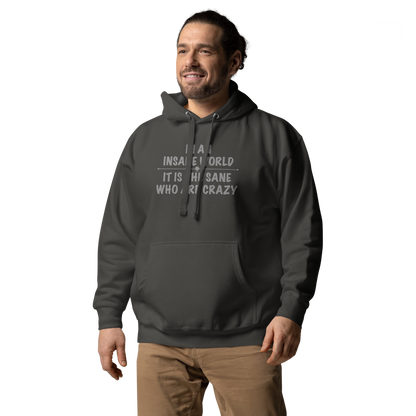 "In an insane world, it is the sane who are crazy" printed on a vintage black unisex hoodie worn by a male