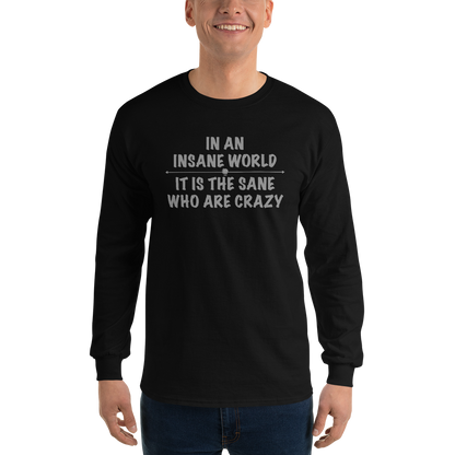 "In an insane world, it is the sane who are crazy" printed on a black men's long sleeve shirt worn by a male