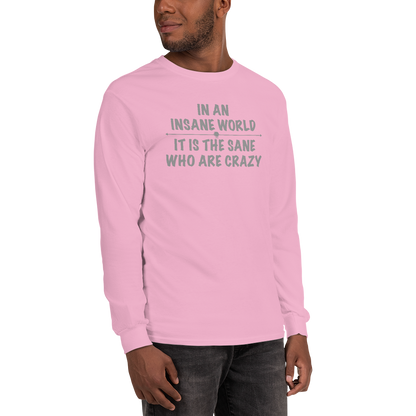 "In an insane world, it is the sane who are crazy" printed on a light pink men's long sleeve shirt worn by a male