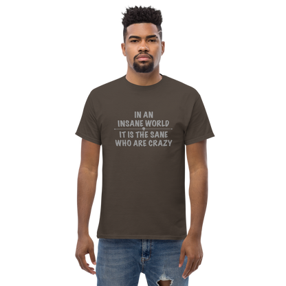 "In an insane world, it is the sane who are crazy" printed on a dark chocolate unisex classic tee worn by a male