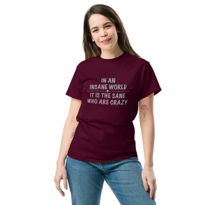 "In an insane world, it is the sane who are crazy" printed on a maroon unisex classic tee worn by a female