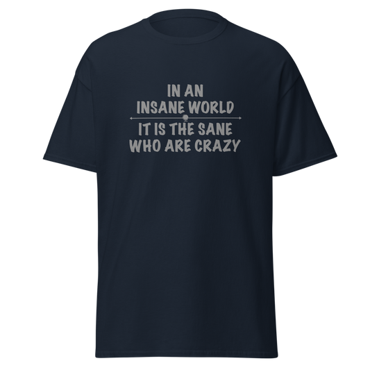 "In an insane world, it is the sane who are crazy" printed on a navy unisex classic tee laying on a flat surface