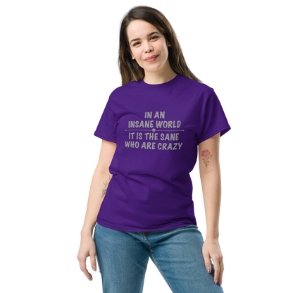 "In an insane world, it is the sane who are crazy" printed on a purple unisex classic tee worn by a female