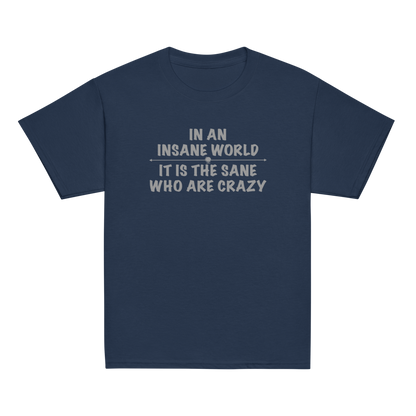 "In an insane world, it is the sane who are crazy" printed on a navy youth classic tee laying on a flat surface