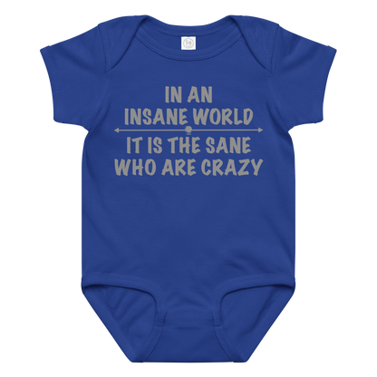 "In an insane world, it is the sane who are crazy" printed on a royal baby jersey bodysuit laying on a flat surface amongst other clothes