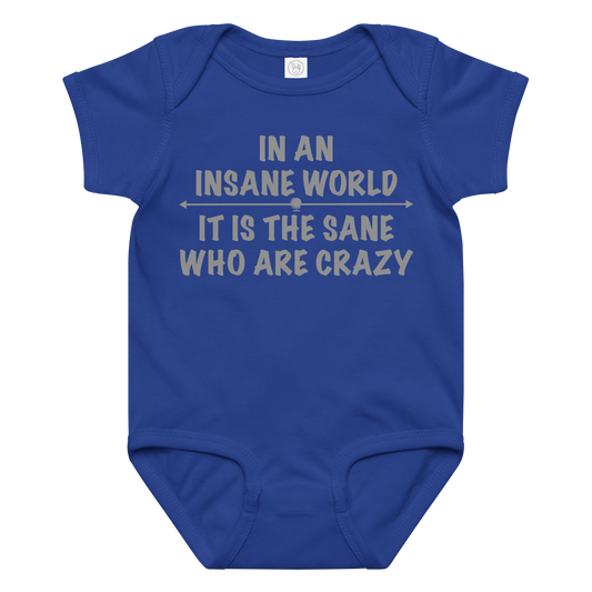 "In an insane world, it is the sane who are crazy" printed on a royal baby jersey bodysuit laying on a flat surface amongst other clothes