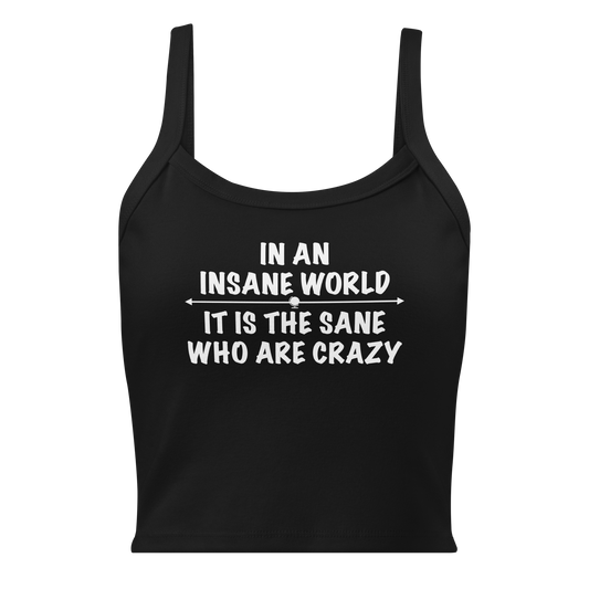 "In an insane world, it is the sane who are crazy" printed on a solid black blend women's micro-rib tanktop laying on a flat surface