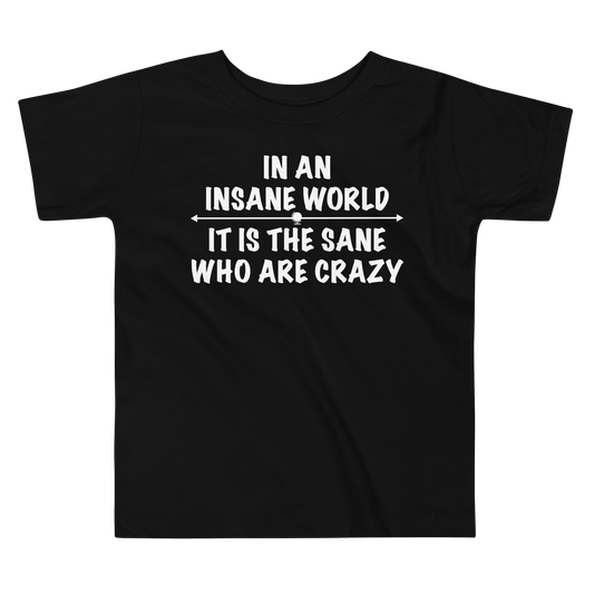 "In an insane world, it is the sane who are crazy" printed on a black toddler short sleeve tee laying on a flat surface