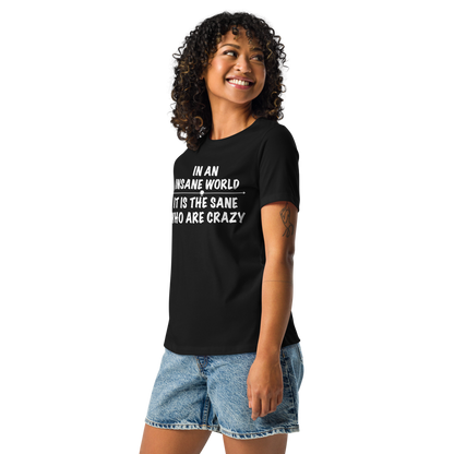 "In an insane world, it is the sane who are crazy" printed on a black women's relaxed t-shirt worn by a female