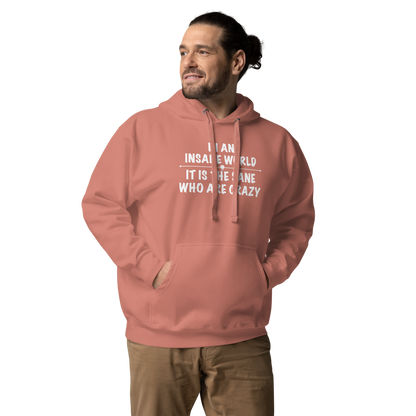 "In an insane world, it is the sane who are crazy" printed on a dusty rose unisex hoodie worn by a male
