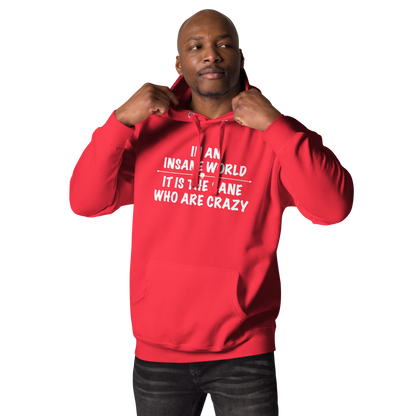"In an insane world, it is the sane who are crazy" printed on a team red unisex hoodie worn by a male