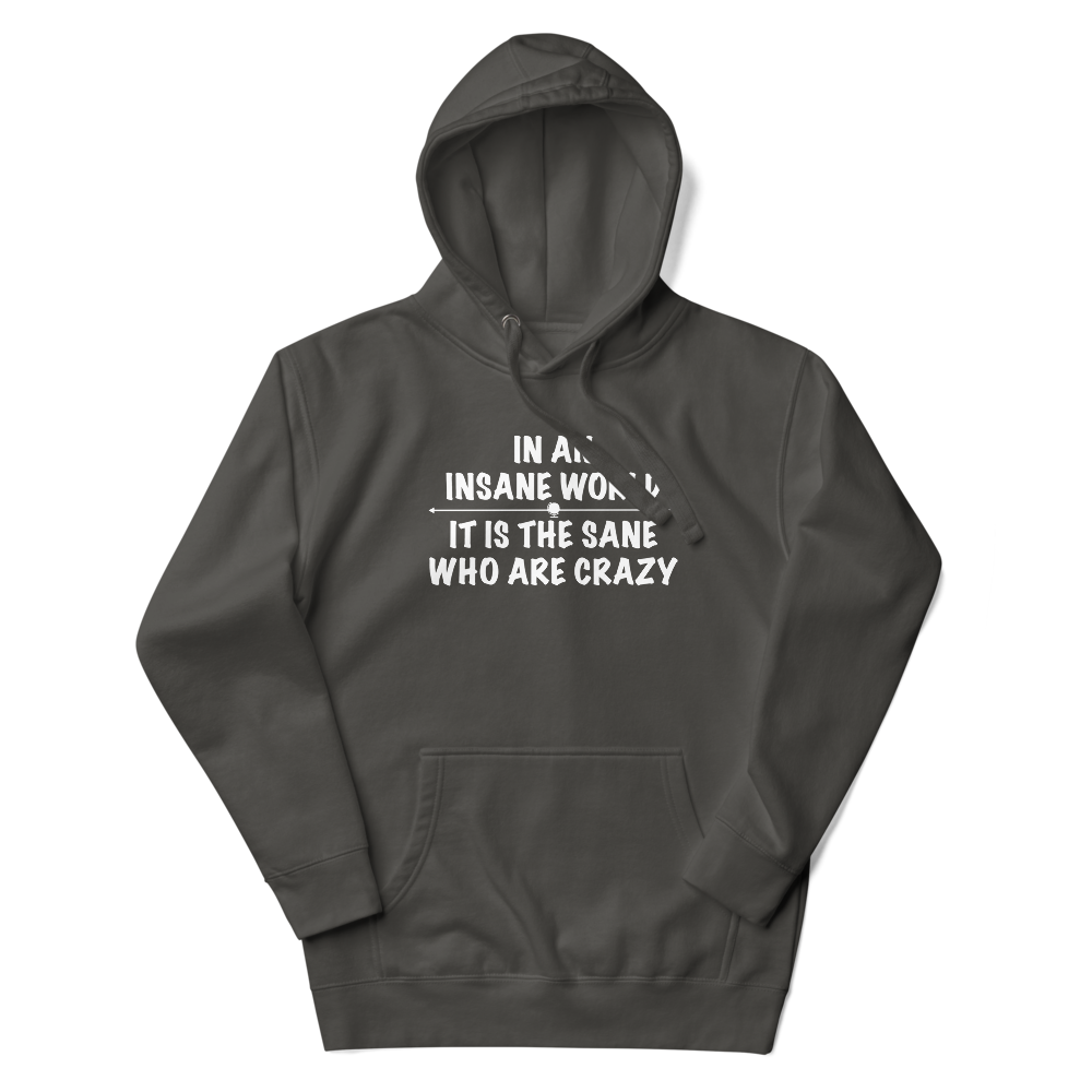 "In an insane world, it is the sane who are crazy" printed on a vintage black unisex hoodie laying on a flat surface with the hood up