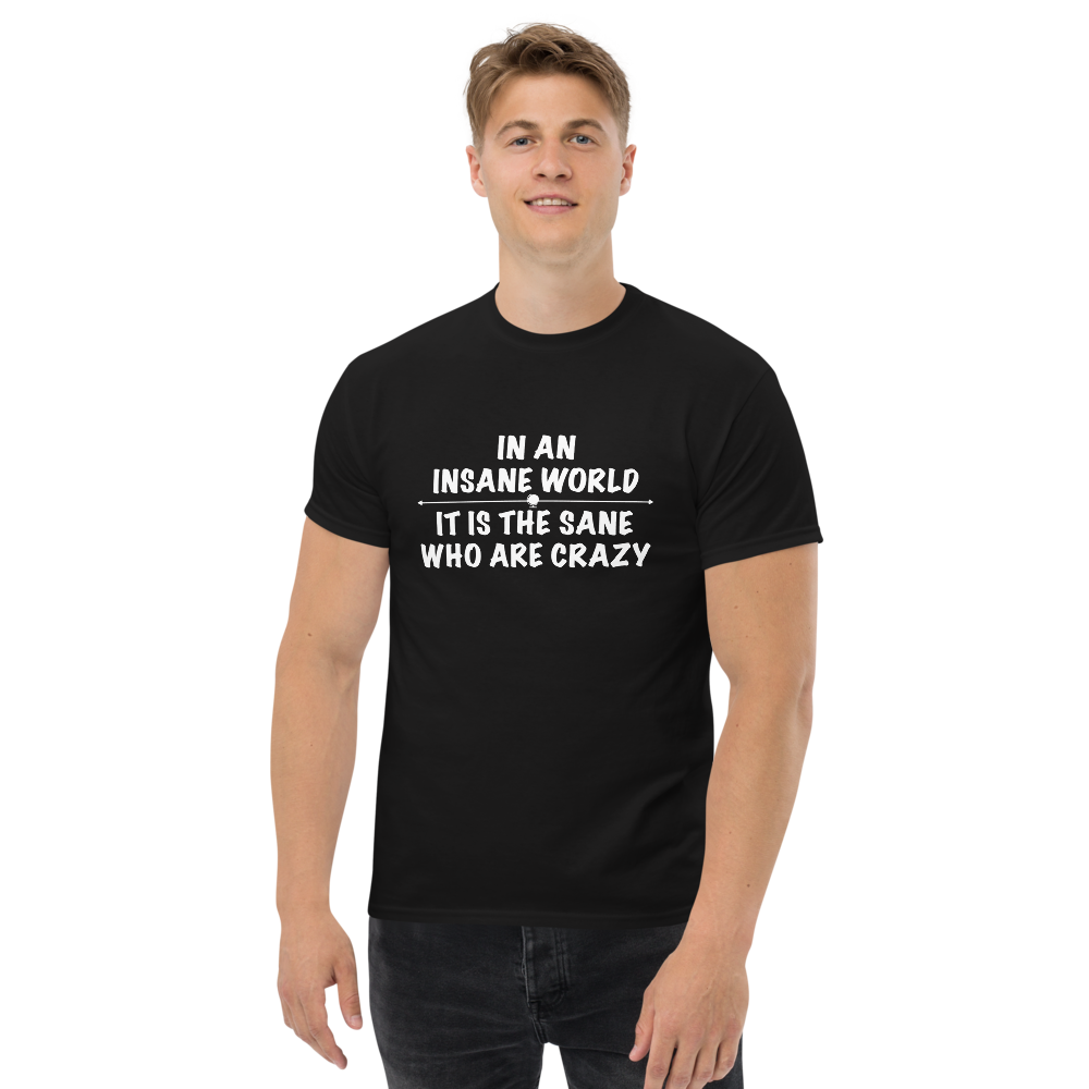 "In an insane world, it is the sane who are crazy" printed on a black unisex classic tee worn by a male