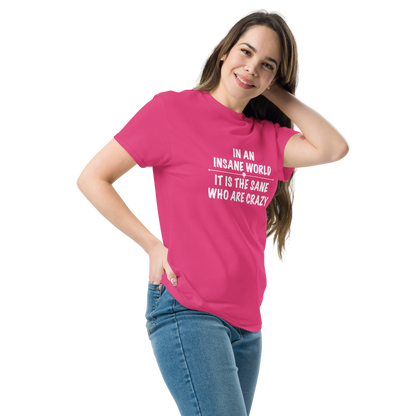 "In an insane world, it is the sane who are crazy" printed on a heliconia unisex classic tee worn by a female