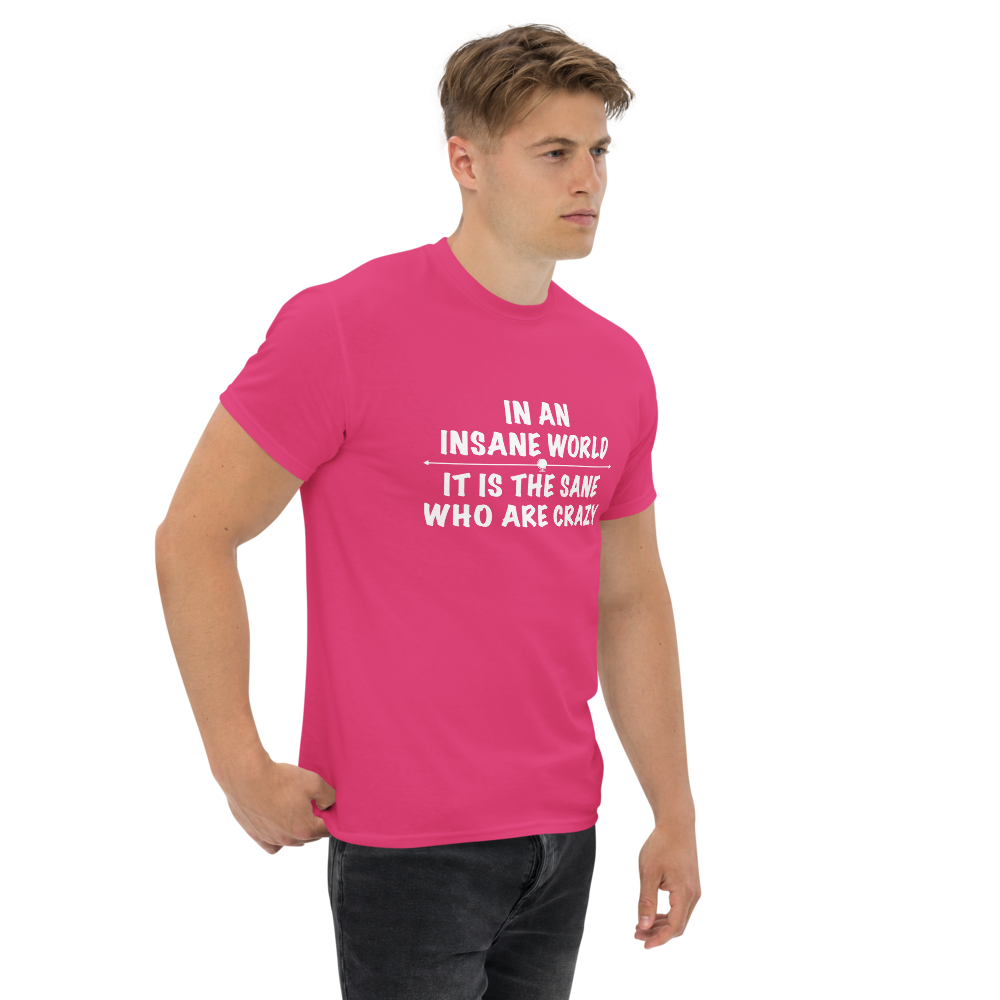 "In an insane world, it is the sane who are crazy" printed on a heliconia unisex classic tee worn by a male