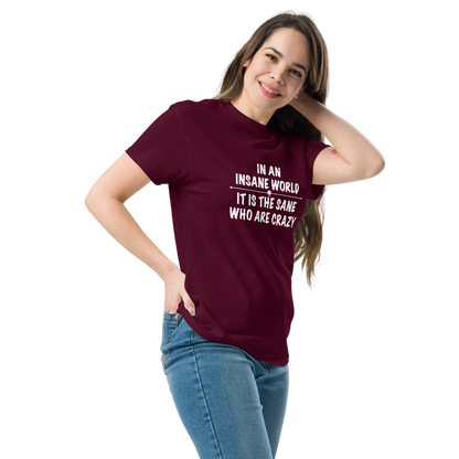"In an insane world, it is the sane who are crazy" printed on a maroon unisex classic tee worn by a female