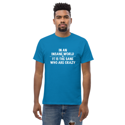 "In an insane world, it is the sane who are crazy" printed on a sapphire unisex classic tee worn by a male