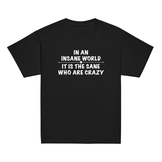 "In an insane world, it is the sane who are crazy" printed on a black youth classic tee laying on a flat surface