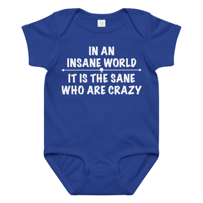 "In an insane world, it is the sane who are crazy" printed on a royal baby jersey bodysuit laying on a flat surface amongst other clothes