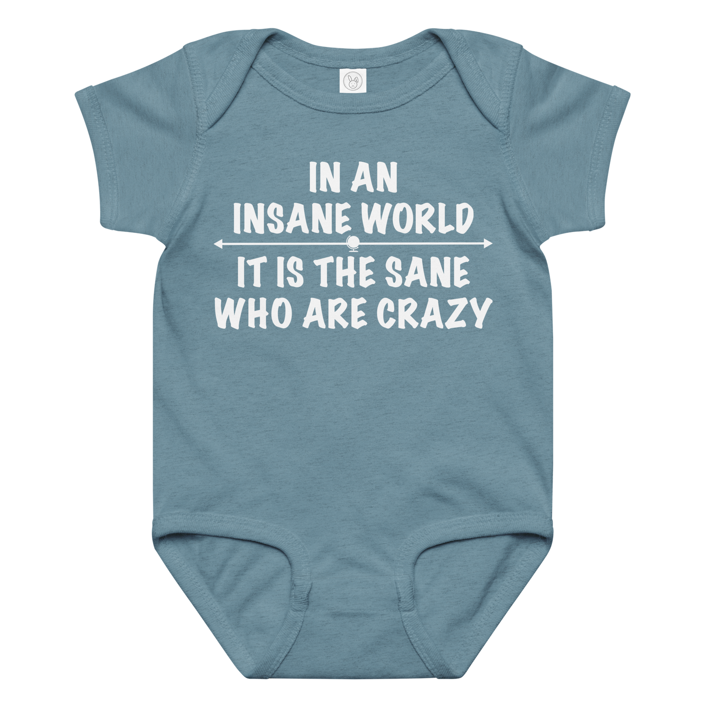 "In an insane world, it is the sane who are crazy" printed on a vintage indigo baby jersey bodysuit laying on a flat surface amongst other clothes