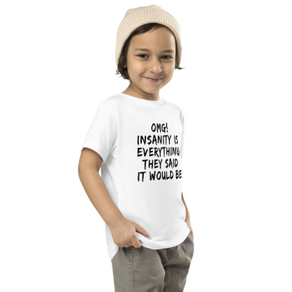 "OMG! Insanity is everything they said it would be" printed on a white toddler short sleeve tee worn by a male who is also wearing a knit cap