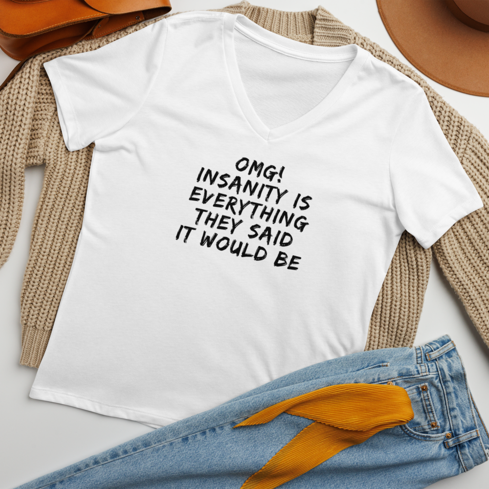 "OMG! Insanity is everything they said it would be" printed on a solid white blend women's relaxed v-neck t-shirt laying on a flat surface amongst other clothes