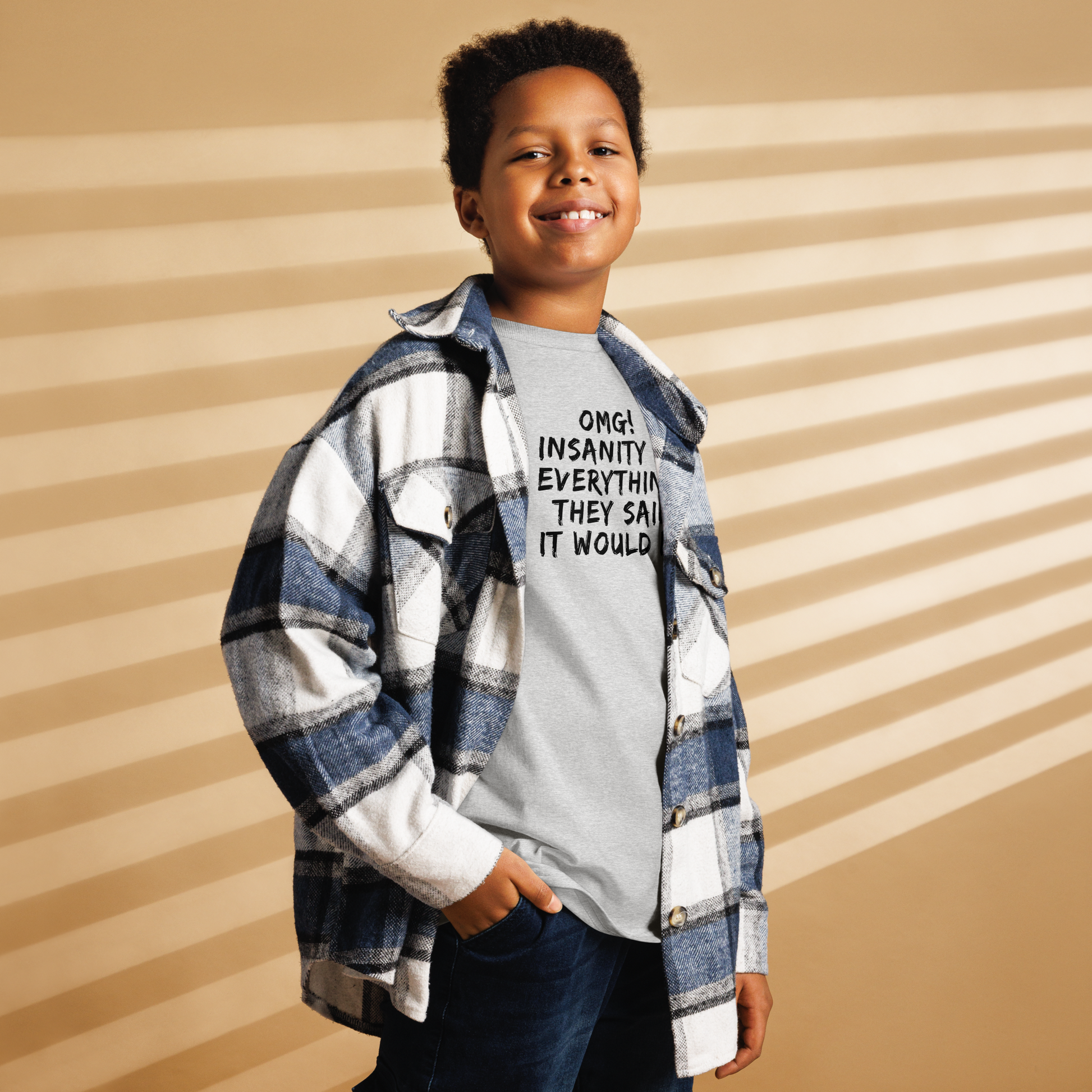 "OMG! Insanity is everything they said it would be" printed on a sport grey youth classic tee worn by a male also wearing a jacket