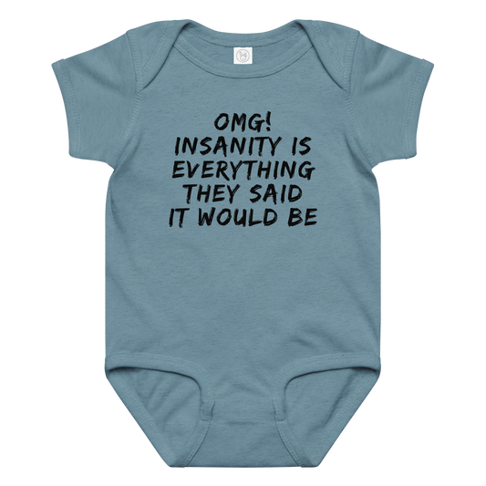 "OMG! Insanity is everything they said it would be" printed on a vintage indigo baby jersey bodysuit laying on a flat surface amongst other clothes